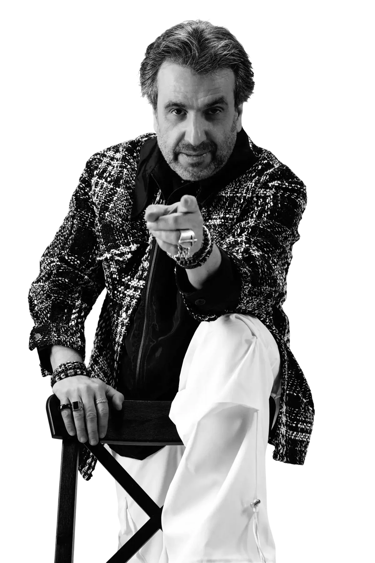 Ramez Basmaji pointing at the camera in a black and white tweed jacket